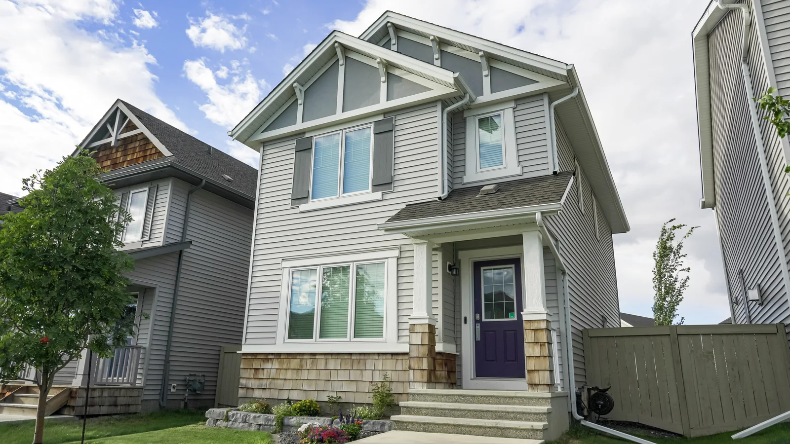 A suburban home with a front porch under a clear blue sky