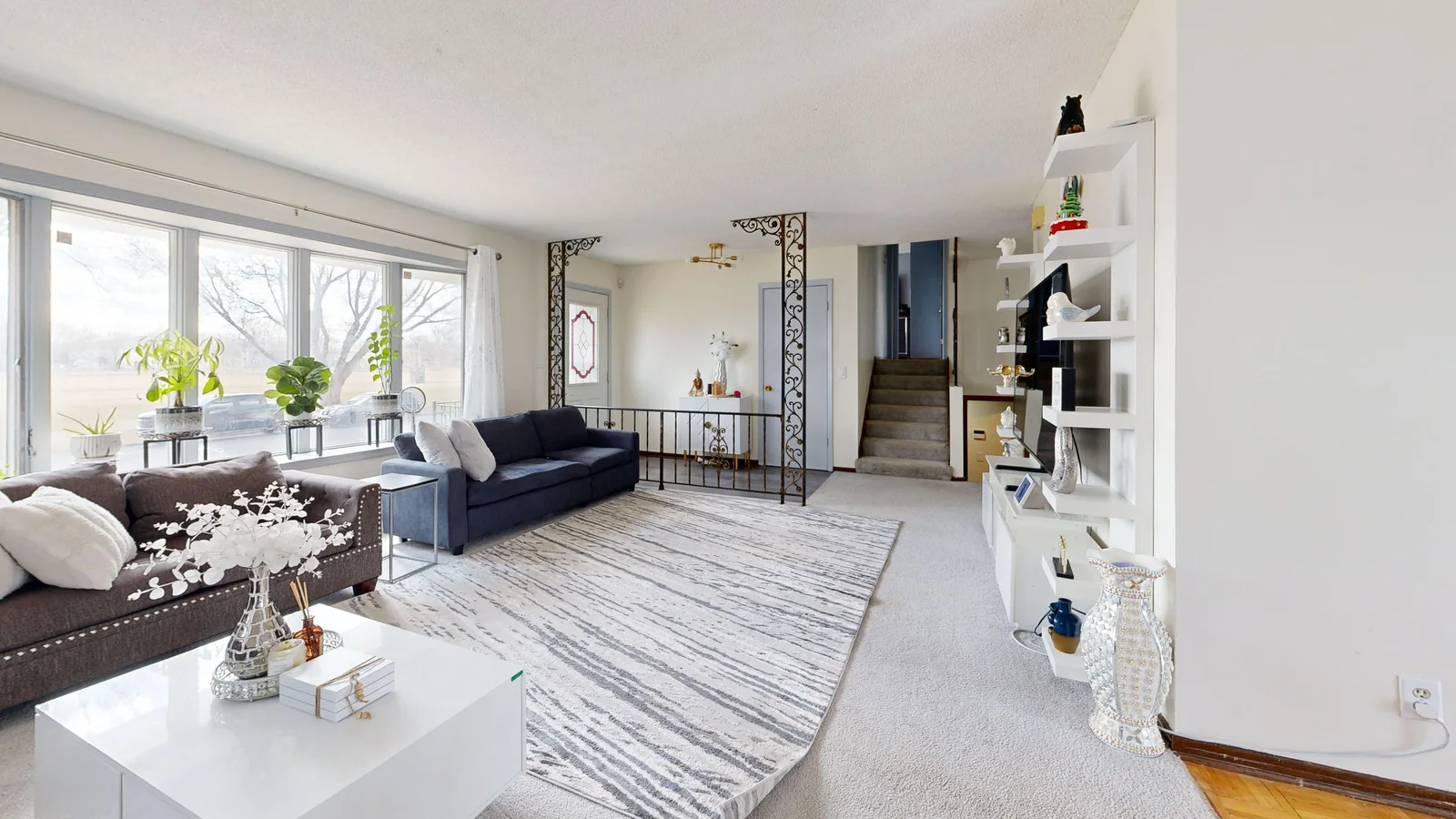 Bright, spacious living room with elegant decor and large windows.