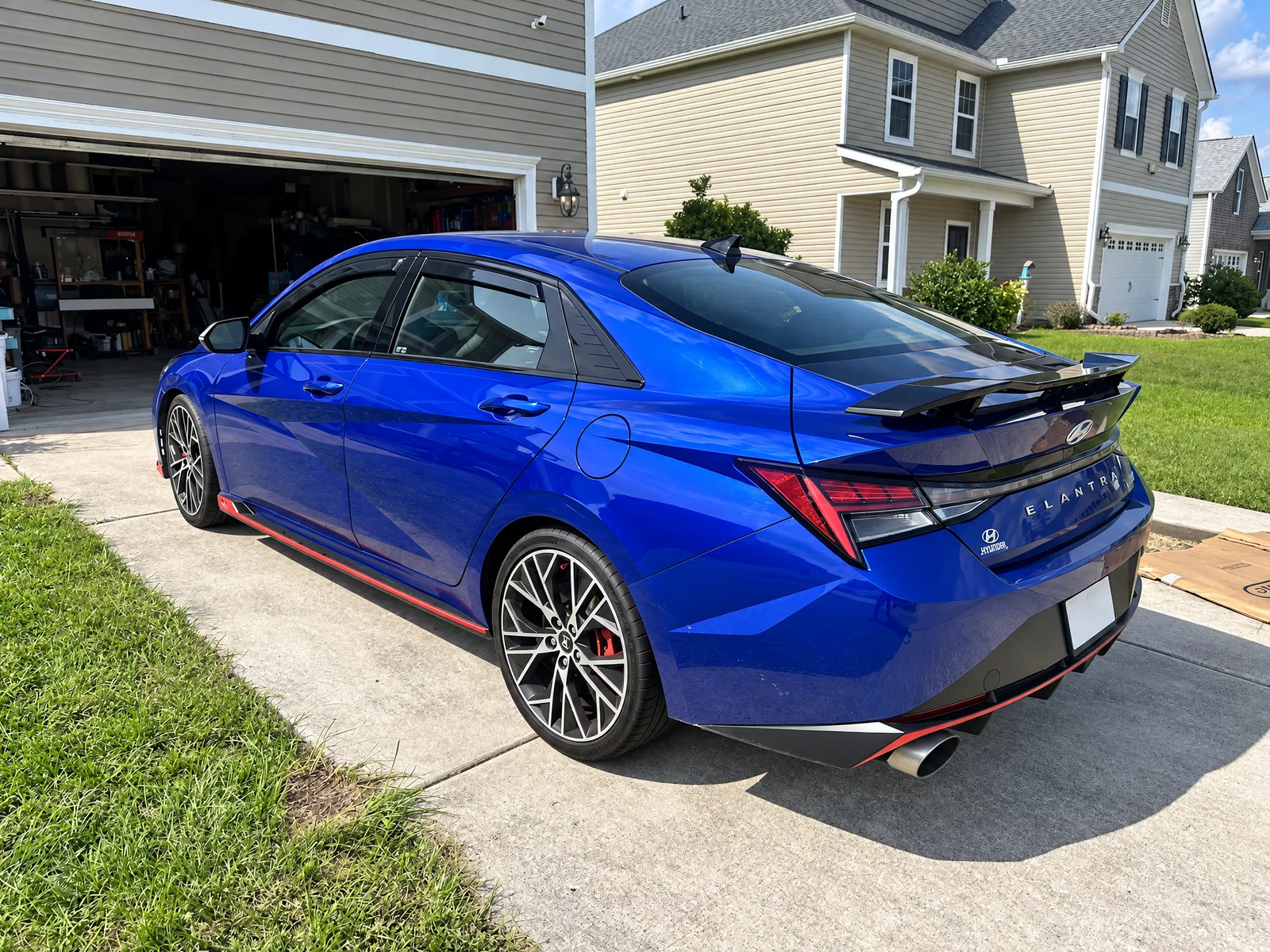 A blue Hyundai Elantra N with tinted windows on a customer’s driveway