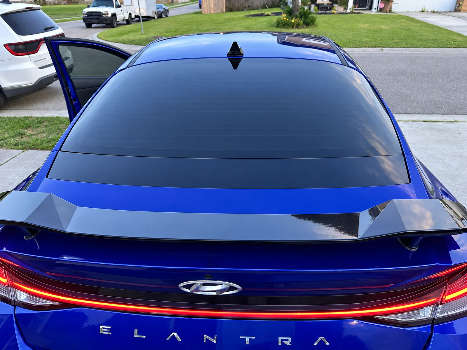 The tinted rear glass of a blue Hyundai Elantra N