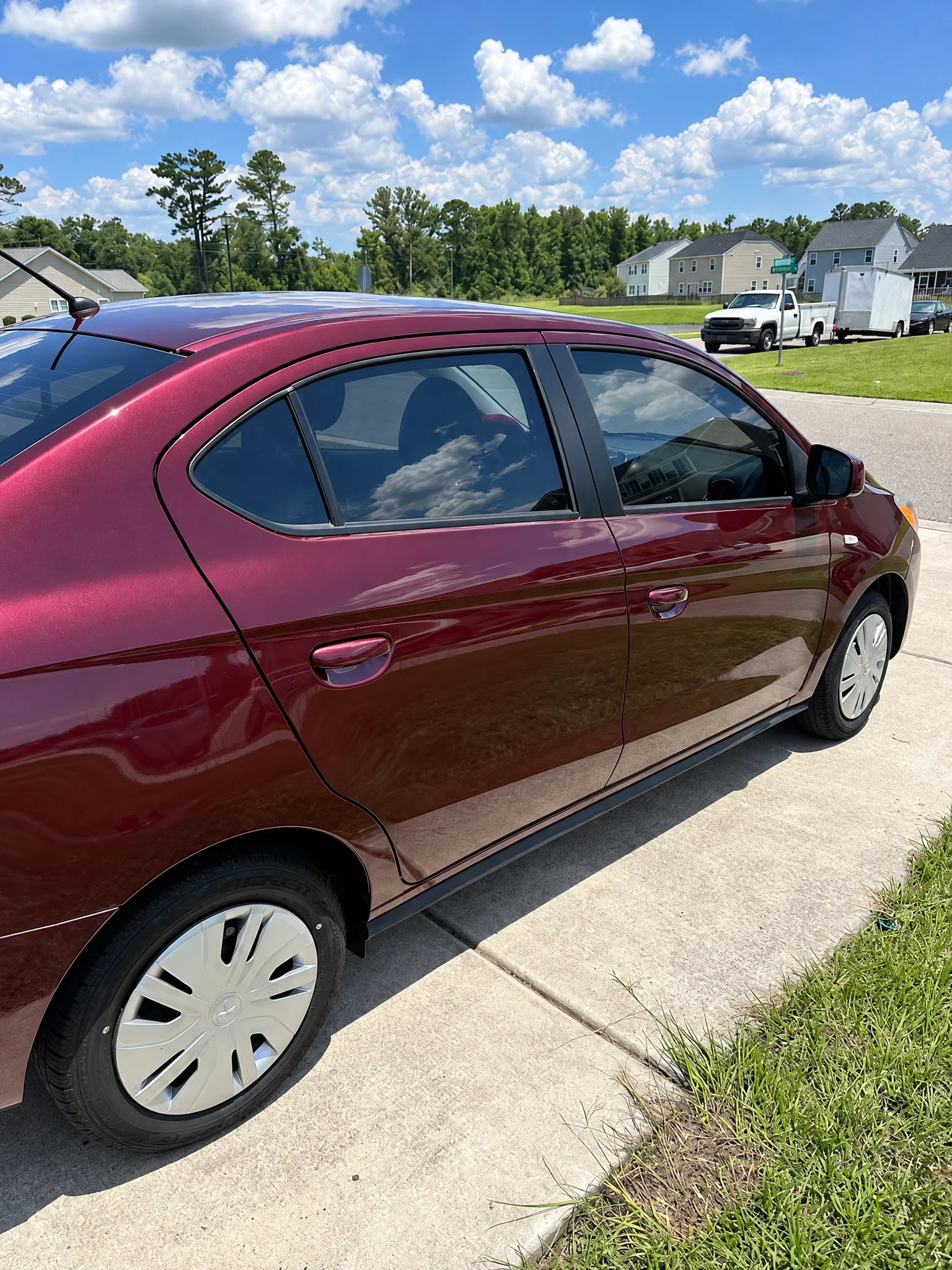 A maroon Mitsubishi Mirage G4 with tinted windows