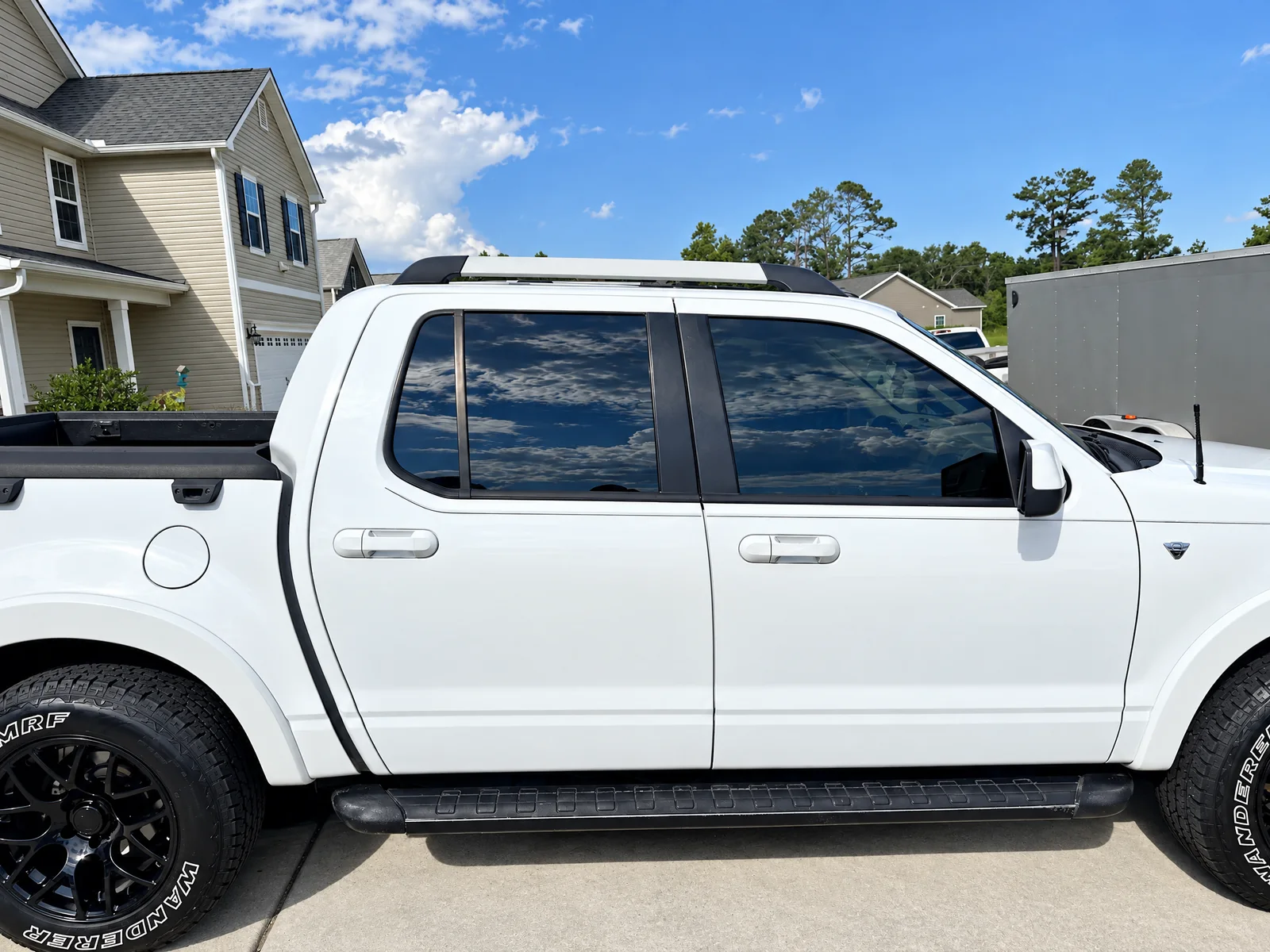 A white Ford Explorer Sport Trac with tinted windows